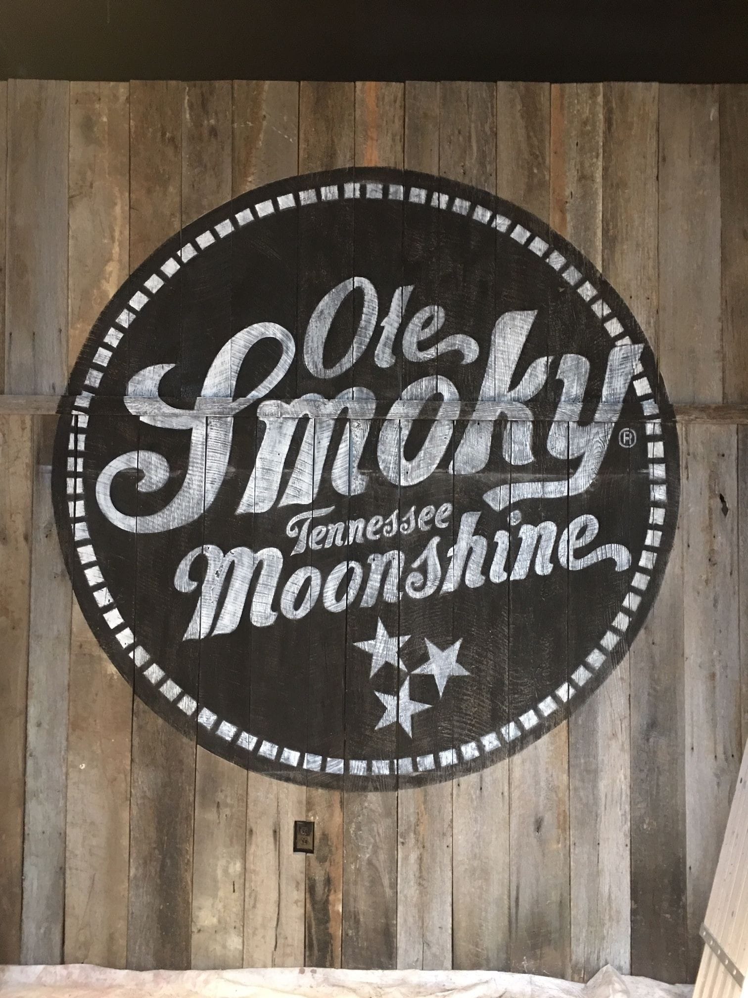 Ole Smoky Tennessee Moonshine logo painted on barnwood located inside Yee Haw Brewing Co. located in Nashville, TN