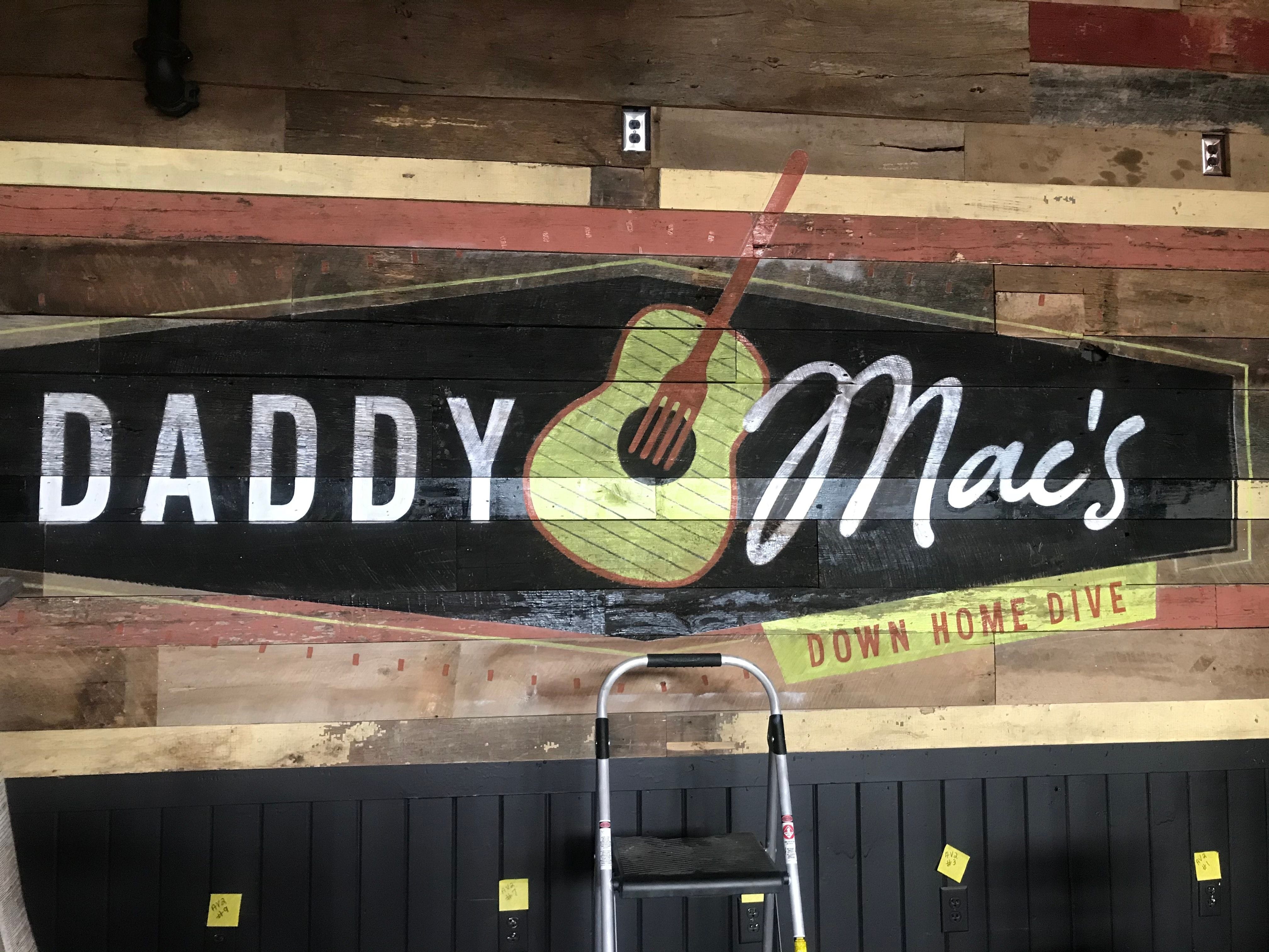 Sign painted on barn wood in Daddy Mac's Down Home Dive in Asheville, NC
