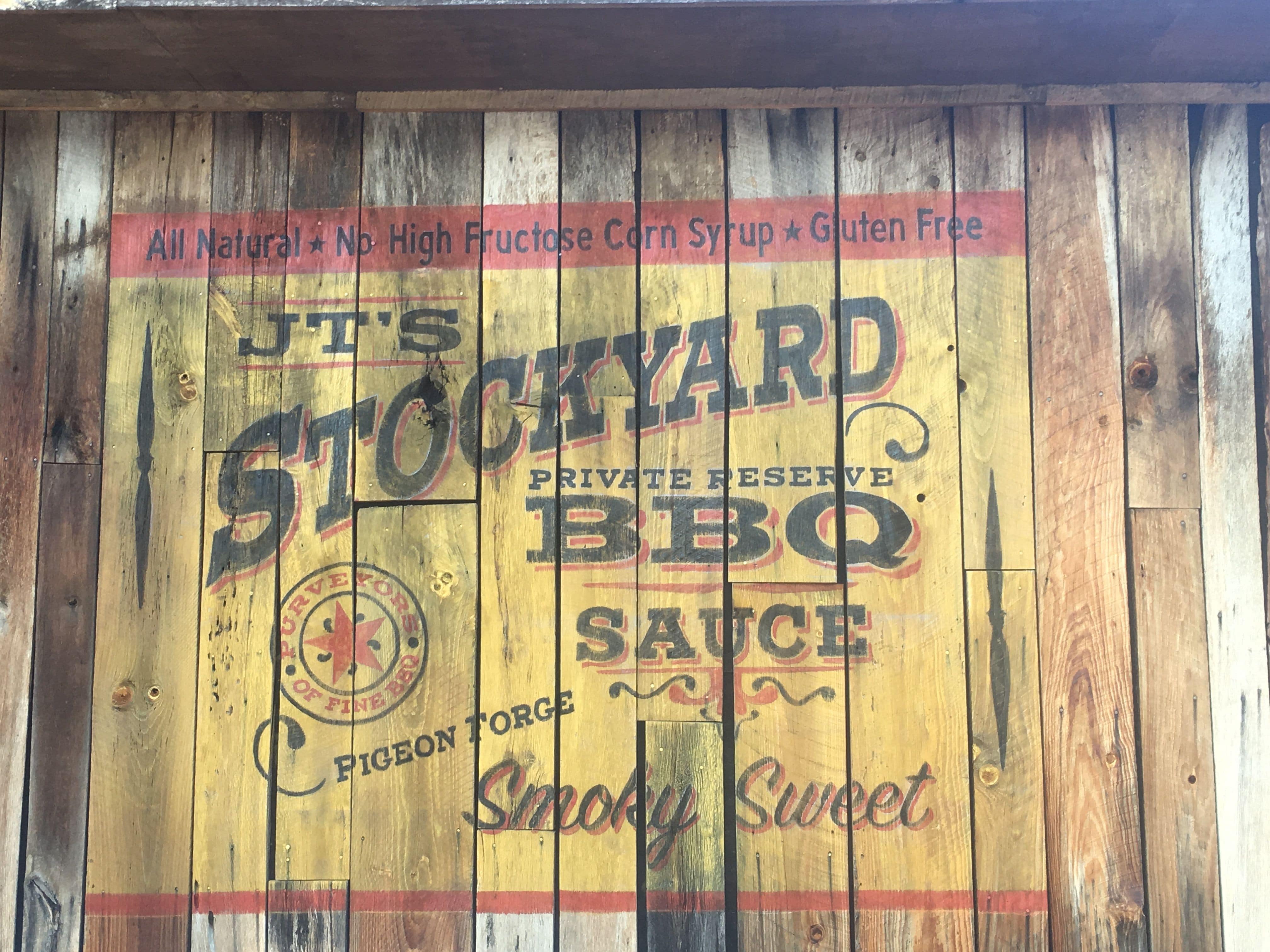 Vintage look Stockyard Sign painted on a barn wood wall outside J.T. Hannah's Kitchen located in Pigeon Forge, TN
