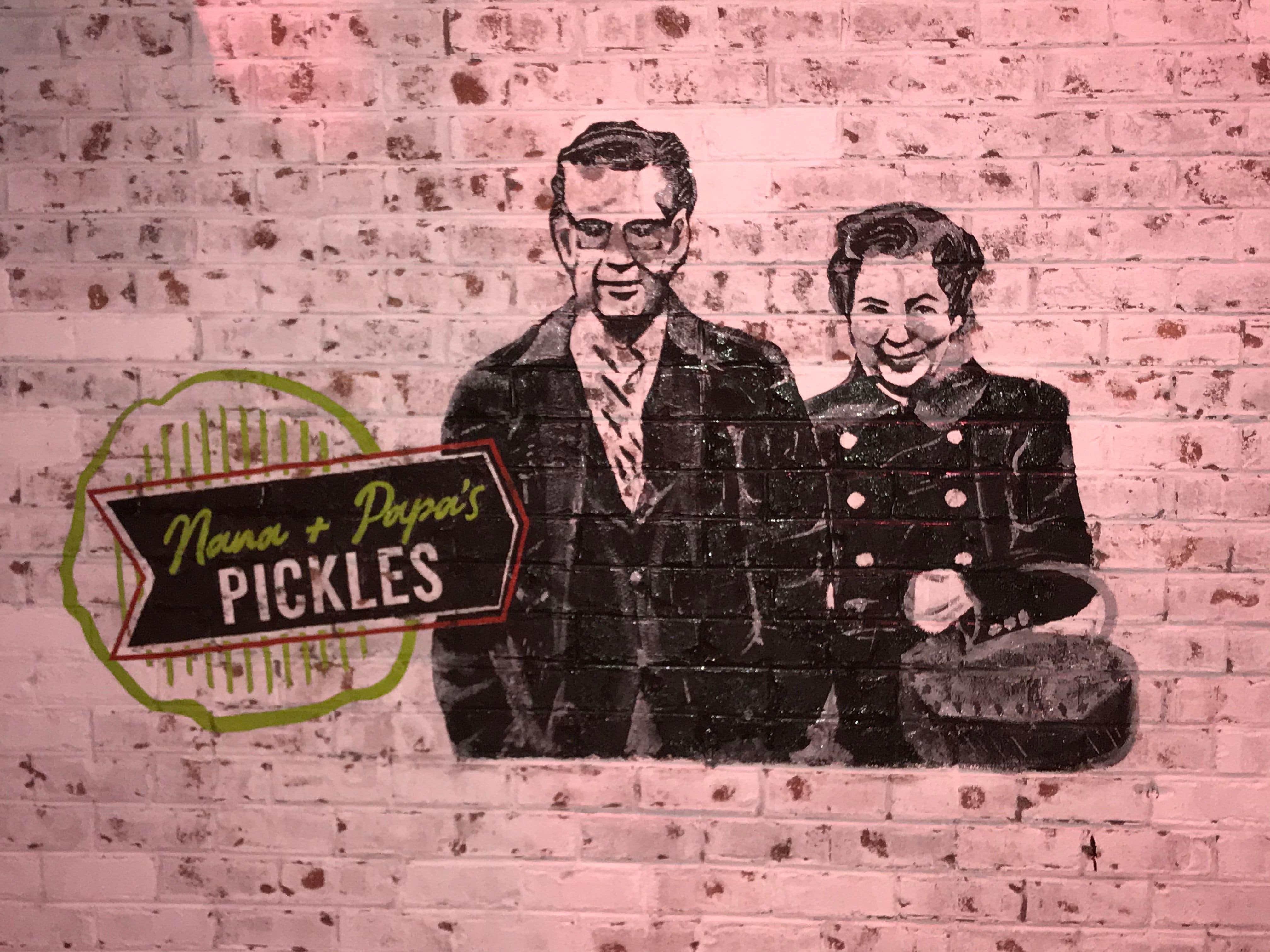 Restaurant owners grandparents painted on interior brick wall. the picture thats on their Pickle's logo.