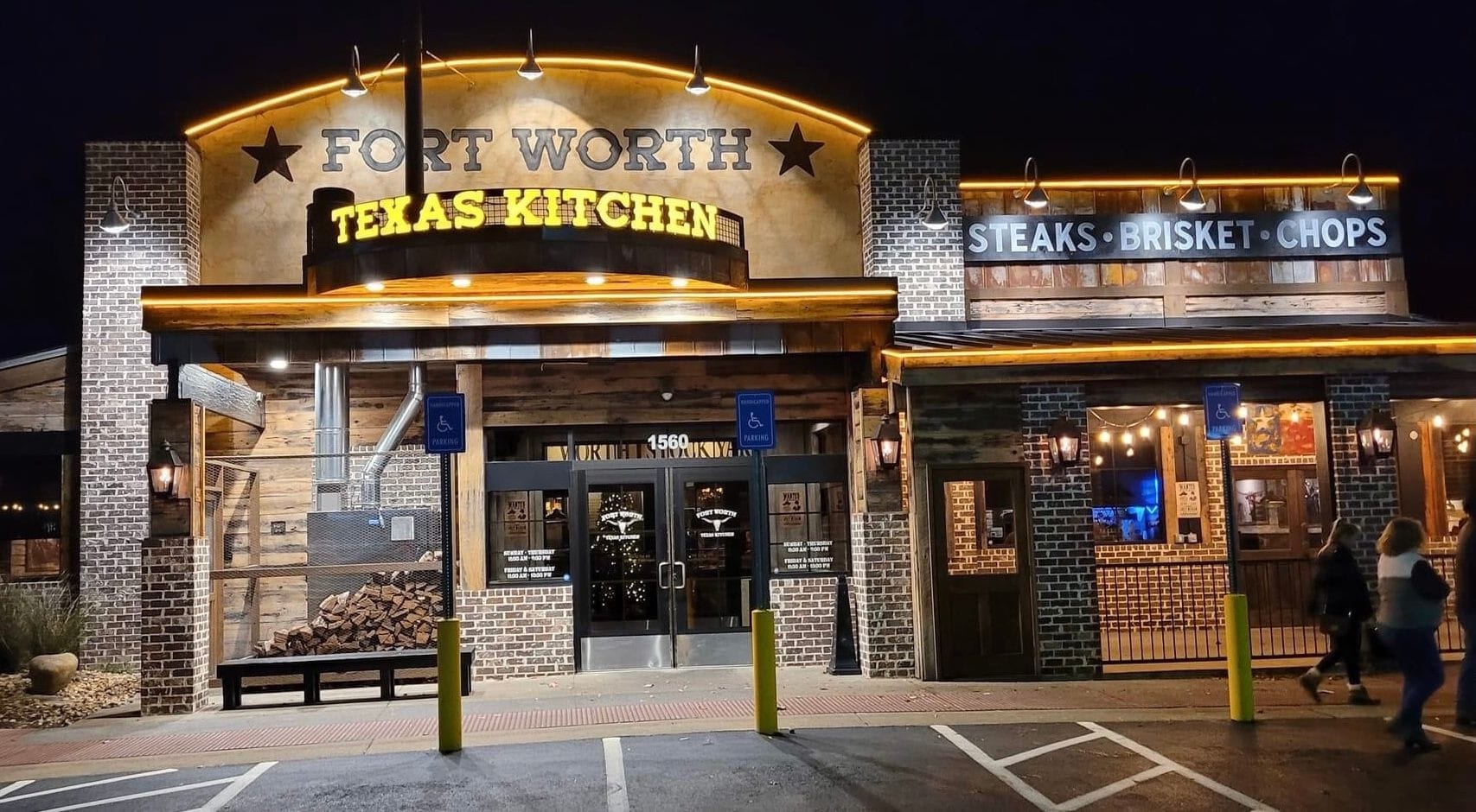  lighted channel letters sign on an arched metal grid base at entrance of Fort Worth Texas Kitchen in Sevierville, TN. Painted Mural on stucco and painted metal