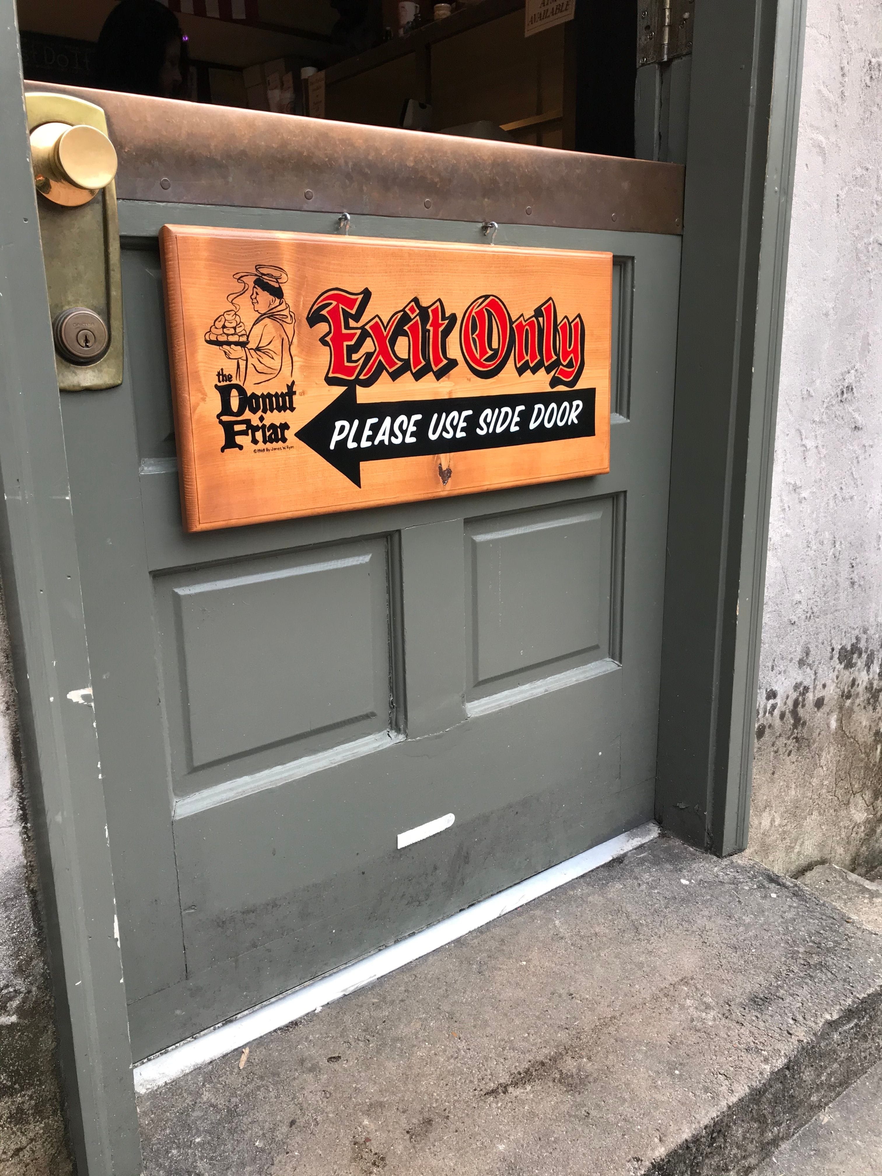 A wooden directional sign was hand painted for the door of the famous "Donut Friar" donut shop located in "The Village" in downtown Gatlinburg,TN