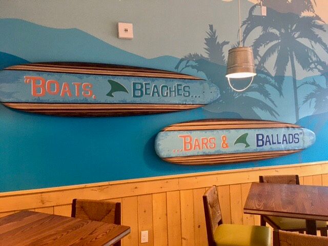 Painted signs on surf board props for the wall in 'Fins Bar" at Camp Margaritaville Hotel in Pigeon Forge,TN