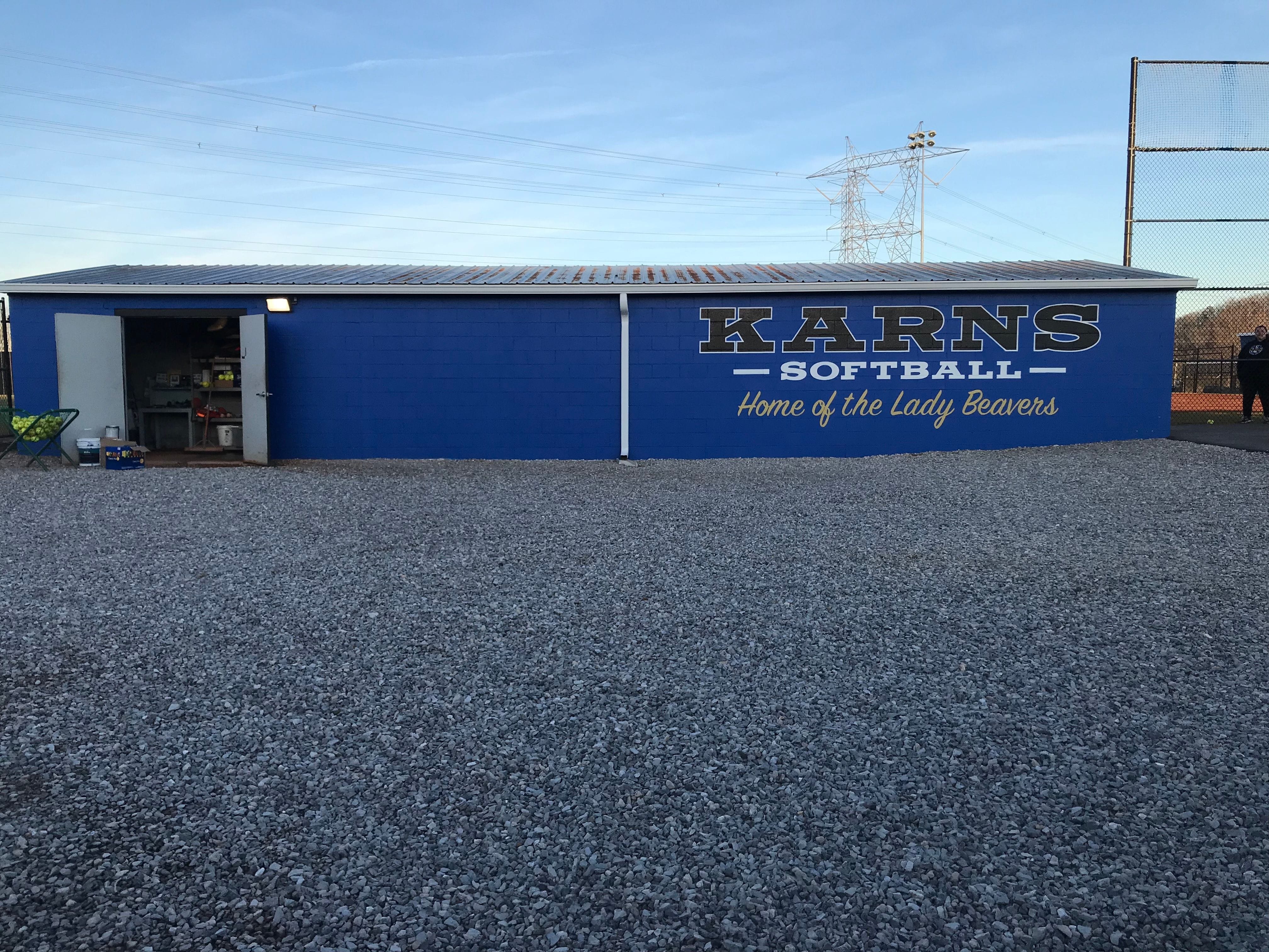Exterior mural painted of school name on block dugout in Karns,TN